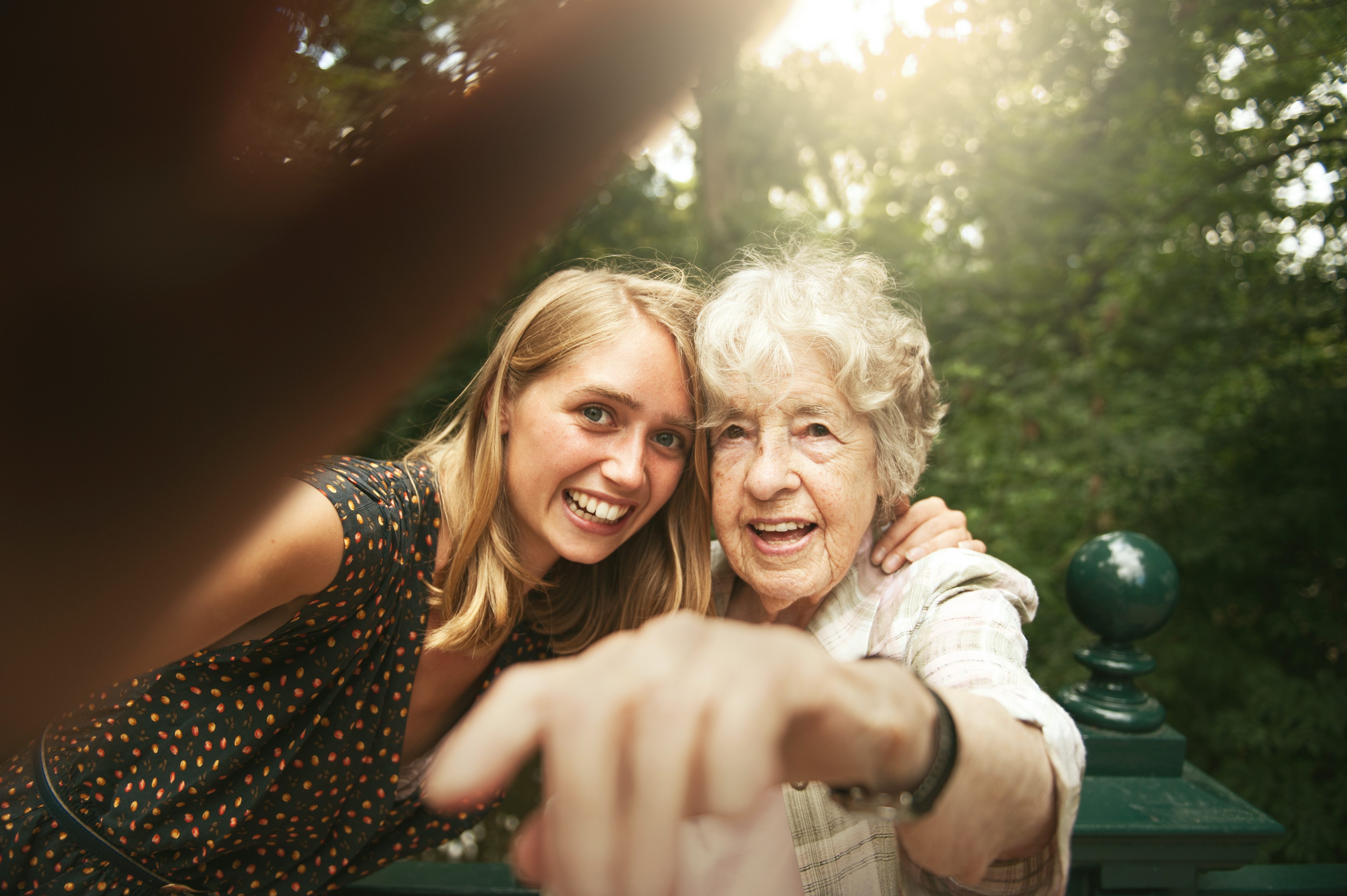 young woman and elderly woman looking at camera