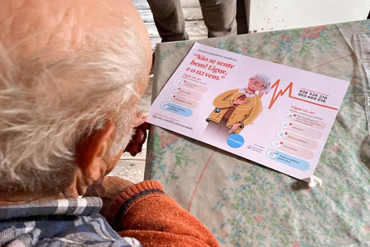 Elderly person looking at a flyer